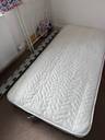 Thumbnail for Single bed with ornate white metal frame and mattress