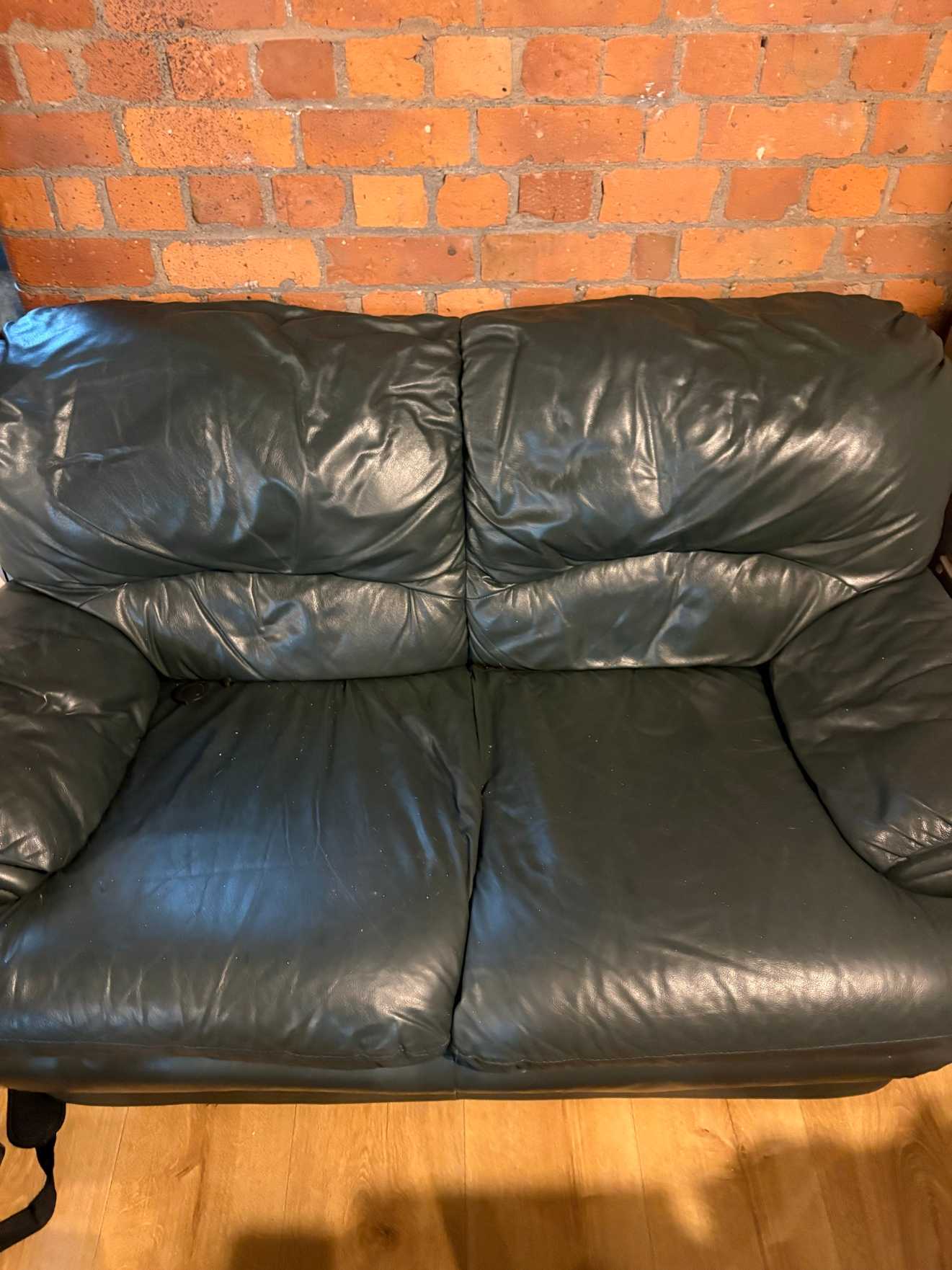Green two seater sofa