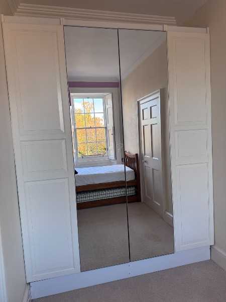 Four IKEA PAX wardrobe doors (230cm height) – two white panelled and two mirrored