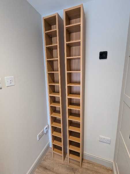 Two tall wooden CD units