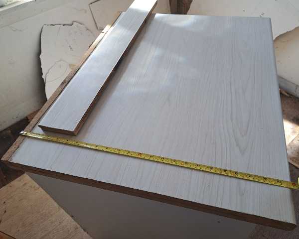 Kitchen laminate bench with open cupboard