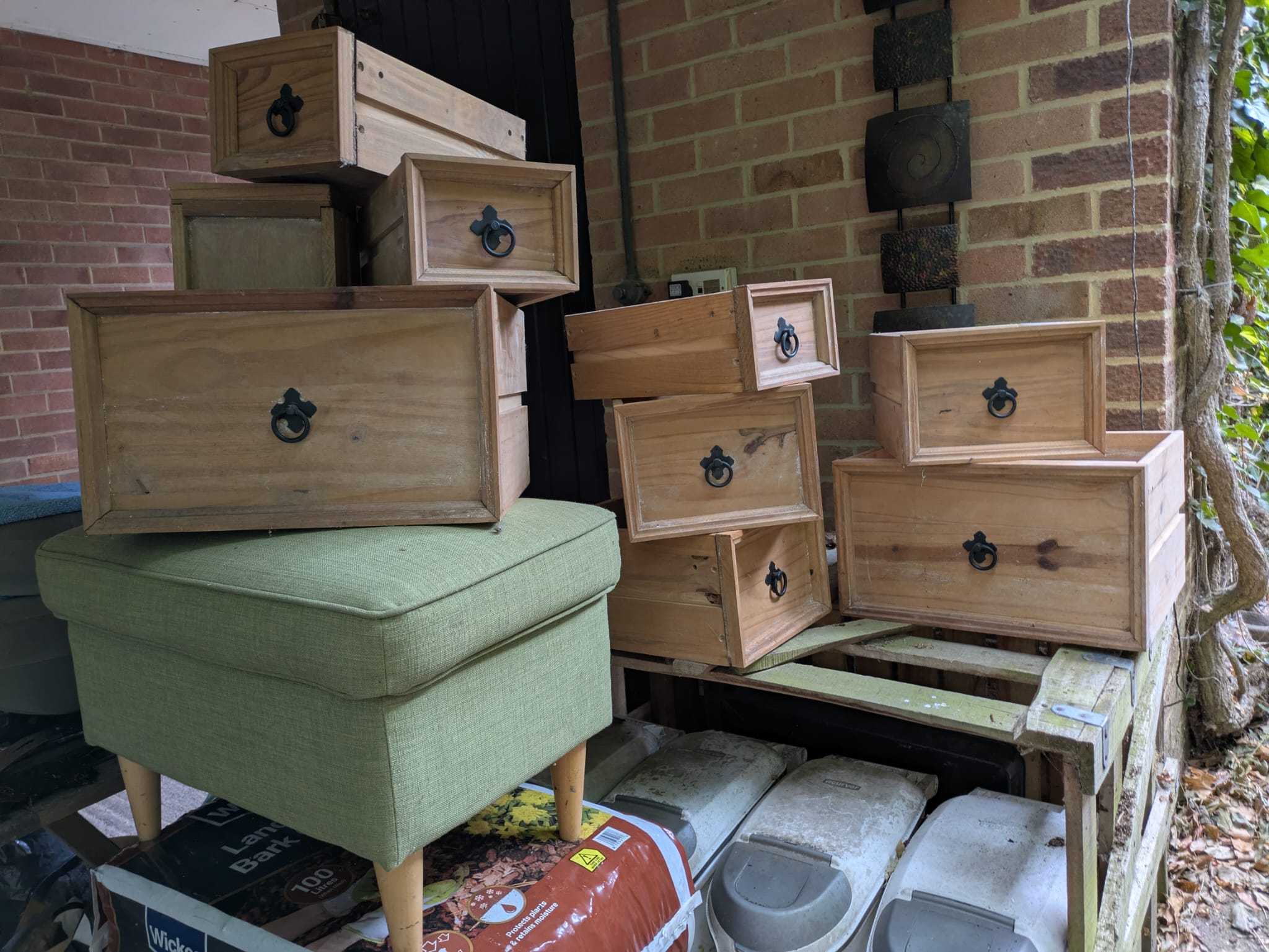 Wooden drawers with Metal handles.  Green ottoman / stool