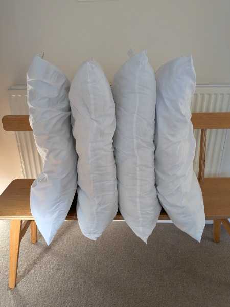 Four pillows and a thick mattress topper
