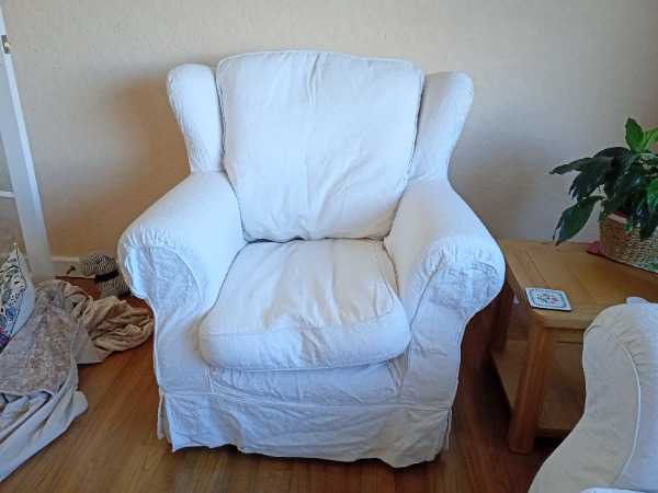 Cream 3 seater sofa and chair with loose covers and fire regs